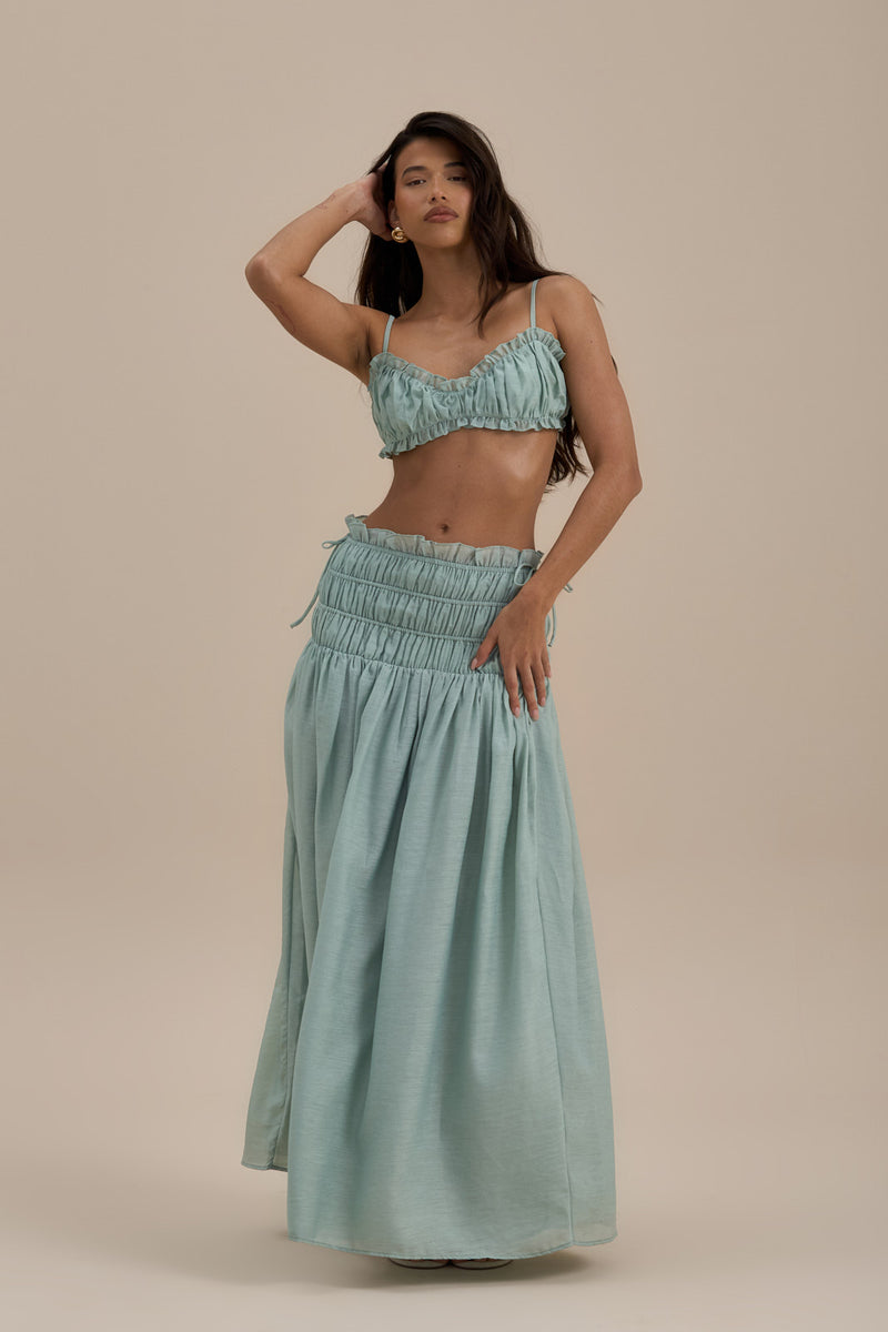 Model wearing Soulie Bra Top in Sage, front view showcasing ruched design and delicate frills - Wanderdoll