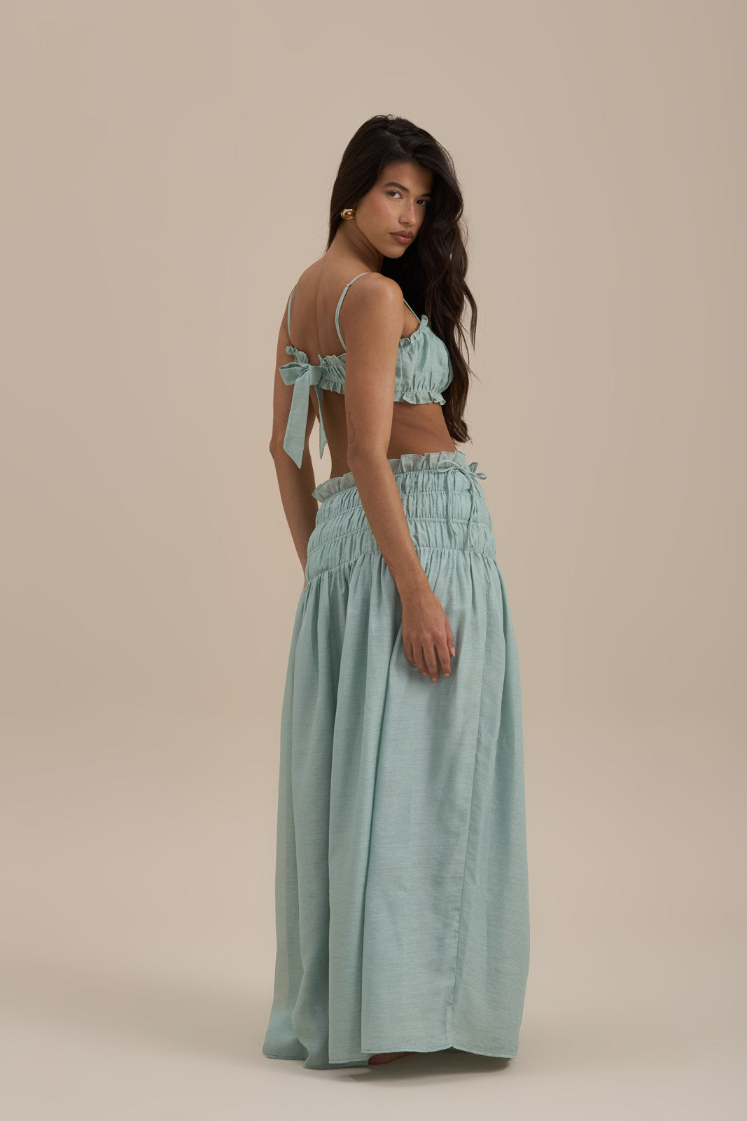 Model wearing Soulie Bra Top in Sage, front view showcasing ruched detail and frill trim - Wanderdoll
