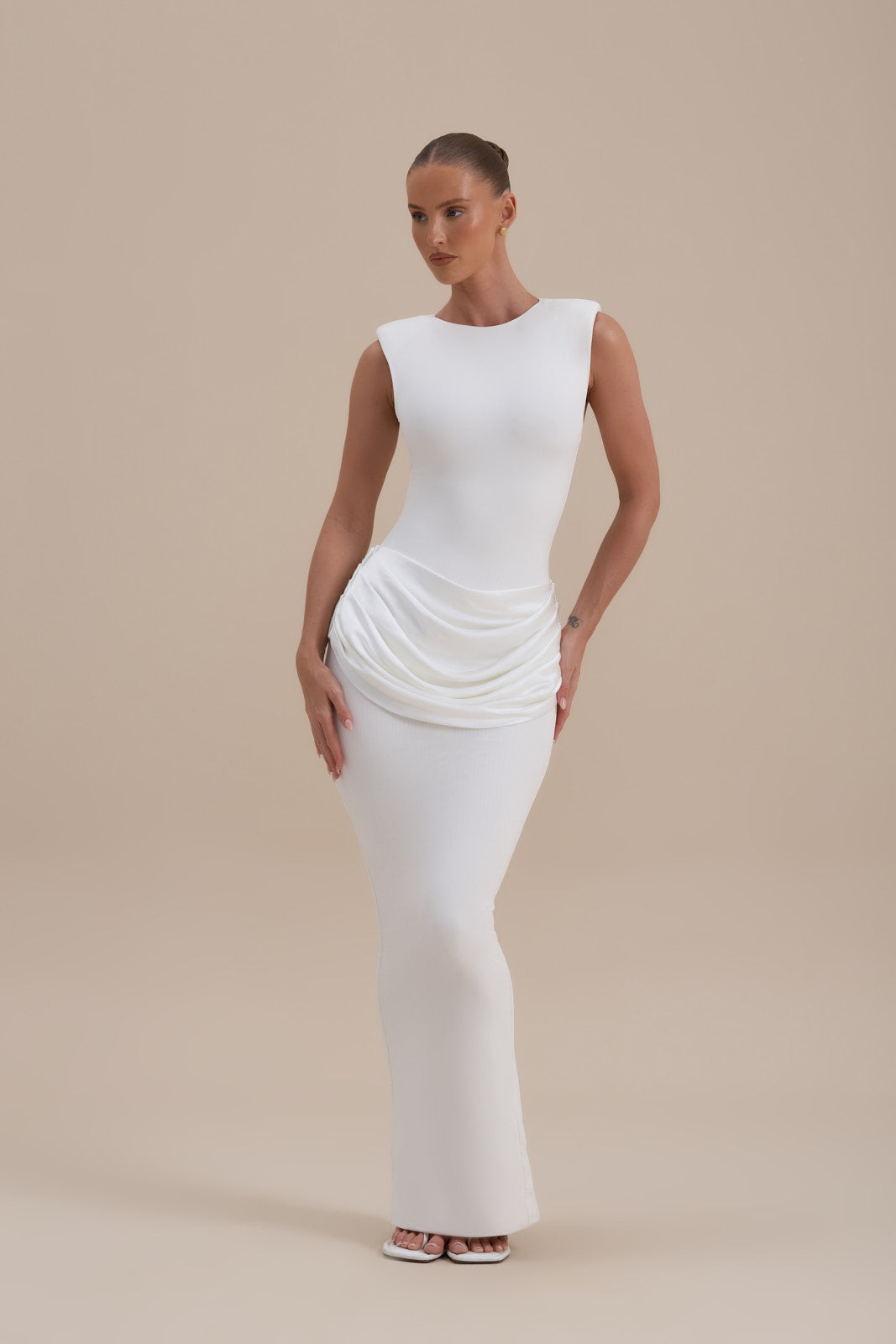 Model wearing Eman Satin Maxi Dress in White, front view highlighting sculpting fit and satin waist drape - Wanderdoll
