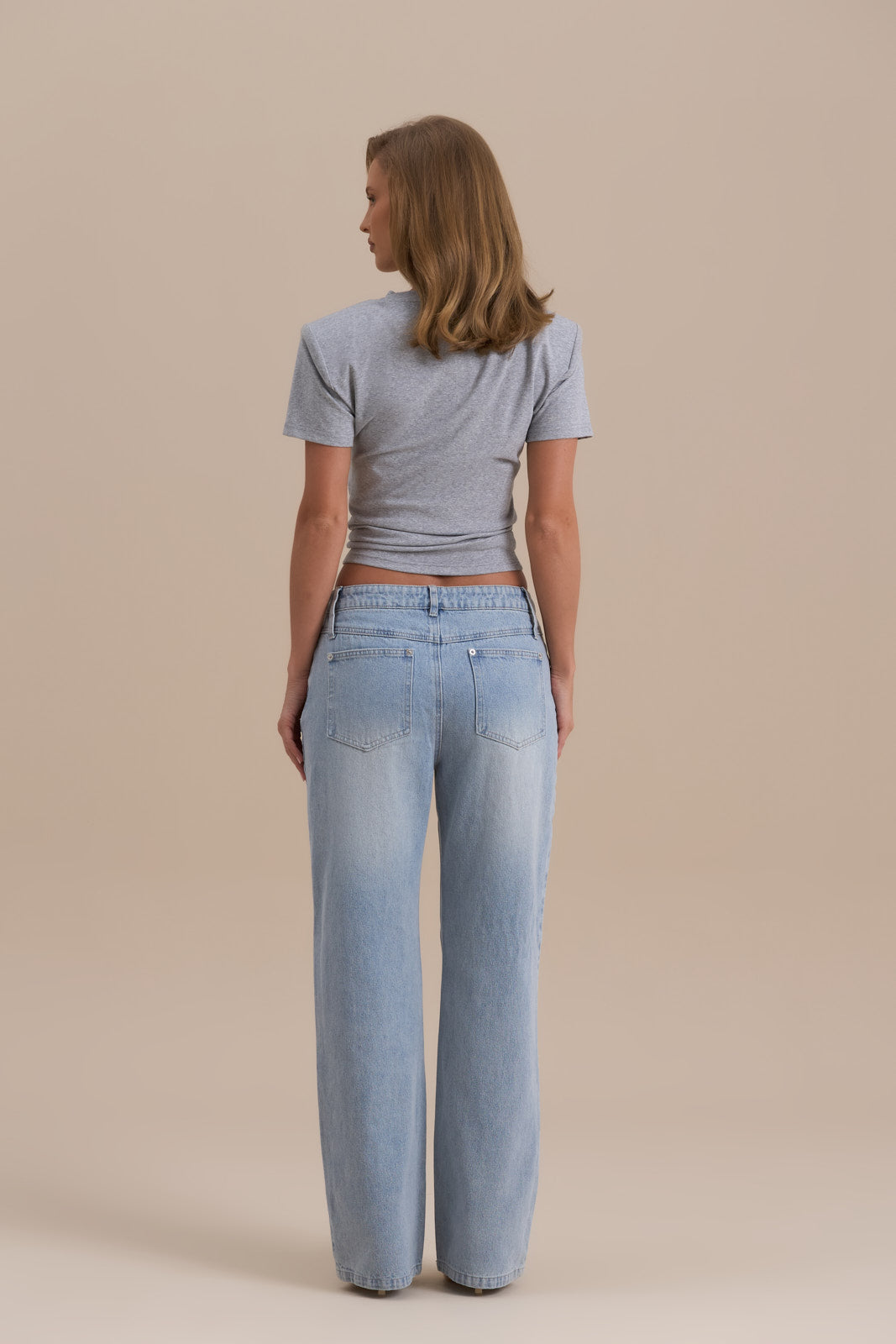 Model wearing grey Knot So Basic T-shirt, front view showcasing hem knot and shoulder pads - Wanderdoll