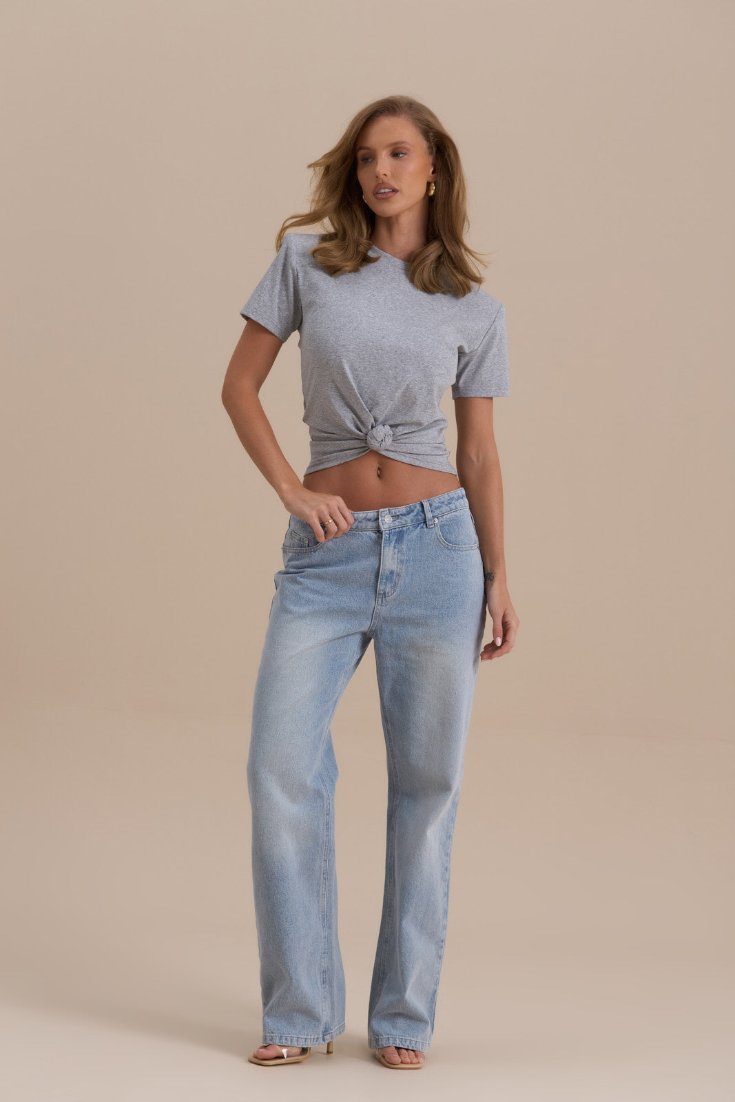 Model wearing Knot So Basic T-shirt in Grey, front view showcasing knot detail and shoulder pads - Wanderdoll