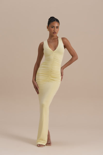 Model wearing Lemon Tate Maxi Dress, elegant outdoor profile showing ruched bodycon fit - Wanderdoll