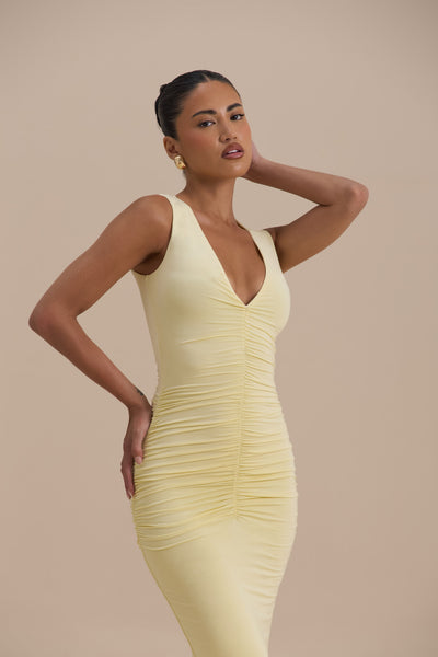 Model wearing Tate Maxi Dress in Lemon, front view showing bodycon fit with ruching and plunging neckline - Wanderdoll