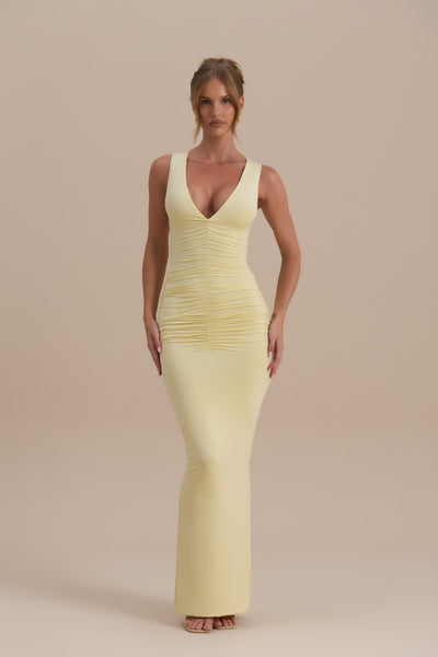 Model wearing Tate Maxi Dress in Lemon, showcasing sleek bodycon fit and ruched detail - Wanderdoll