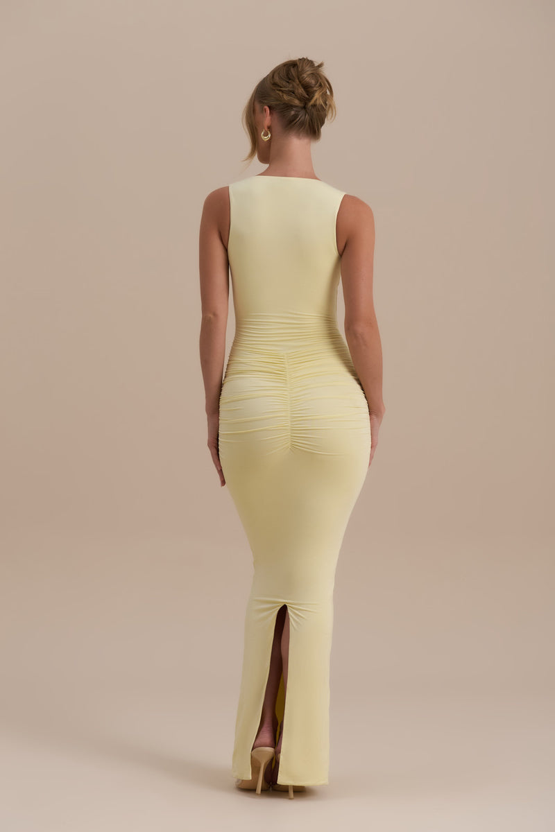 Model wearing Tate Maxi Dress in Lemon, showcasing sleek bodycon fit and ruched detail - Wanderdoll