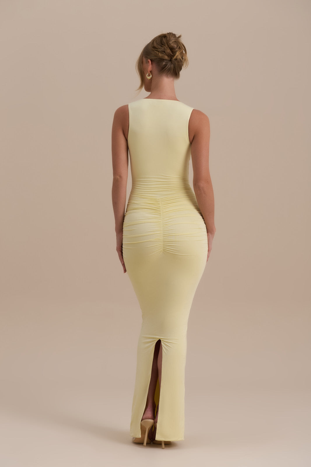 Model wearing Tate Maxi Dress in Lemon, front view with ruched bodycon fit - Wanderdoll